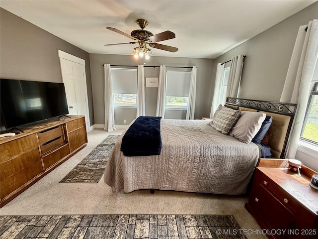 bedroom with baseboards, a ceiling fan, and carpet