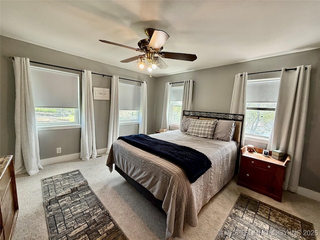 bedroom with baseboards, light colored carpet, and ceiling fan