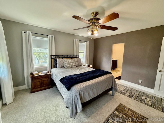 bedroom featuring a ceiling fan, light colored carpet, baseboards, and multiple windows