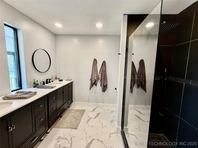 bathroom featuring a walk in shower, recessed lighting, marble finish floor, double vanity, and baseboards