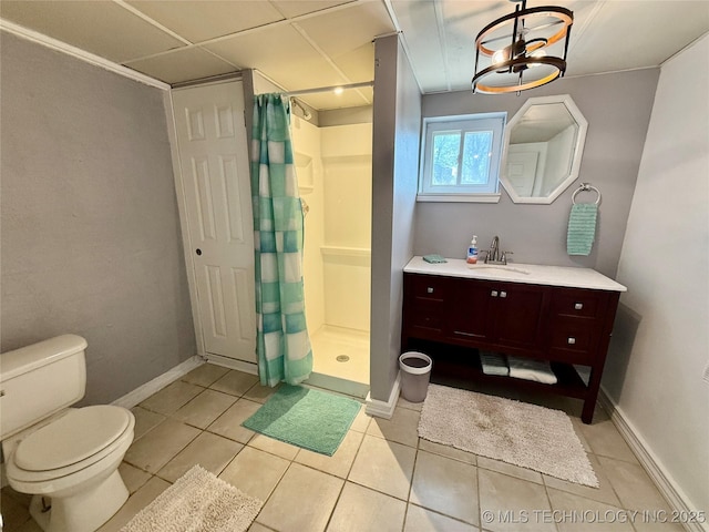 full bathroom featuring toilet, a shower stall, vanity, and baseboards