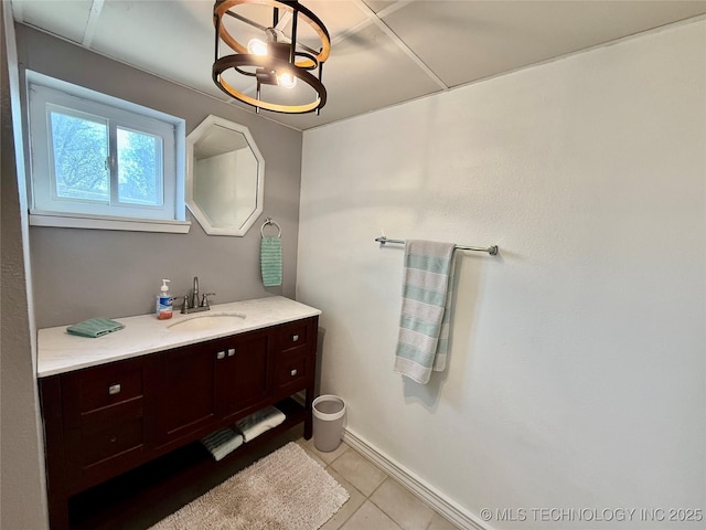 bathroom with vanity, baseboards, and tile patterned flooring