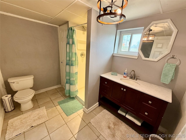bathroom with a shower stall, vanity, tile patterned flooring, toilet, and a notable chandelier