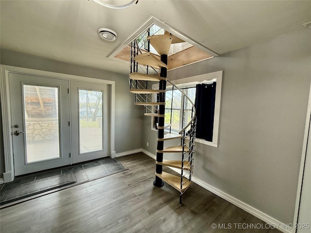 doorway with baseboards, stairs, wood finished floors, and a healthy amount of sunlight
