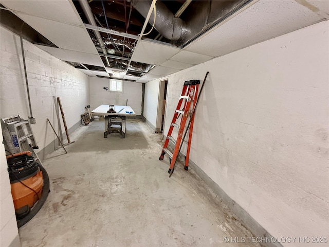 below grade area featuring concrete block wall