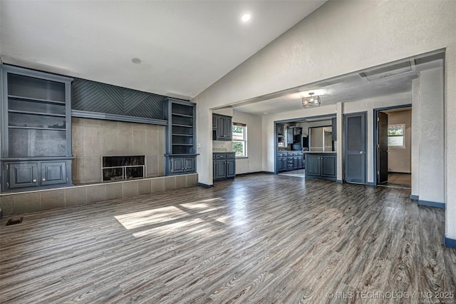 804 S Sooner Rd, Midwest City, OK 73110 - unfurnished living room with wood finished floors, visible vents, a fireplace, and baseboards
