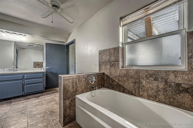 804 S Sooner Rd, Midwest City, OK 73110 - full bath with vanity, a textured wall, a textured ceiling, a ceiling fan, and a garden tub