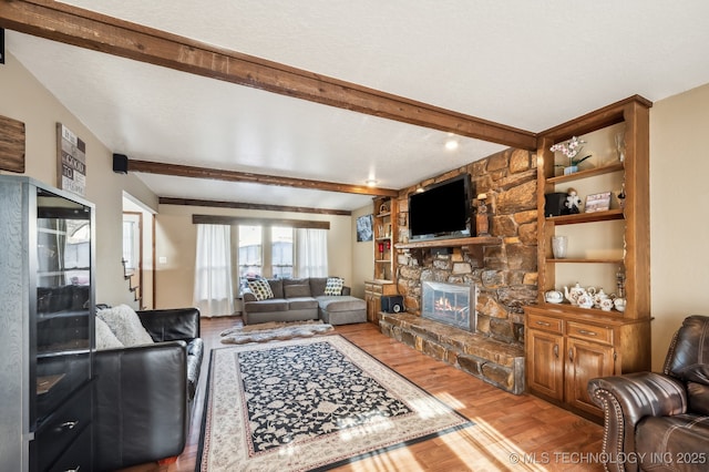 1604 S Chestnut Ave, Broken Arrow, OK 74012 - living room featuring wood finished floors, beamed ceiling, and a stone fireplace