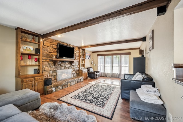 1604 S Chestnut Ave, Broken Arrow, OK 74012 - living area with beam ceiling, wood finished floors, and a stone fireplace