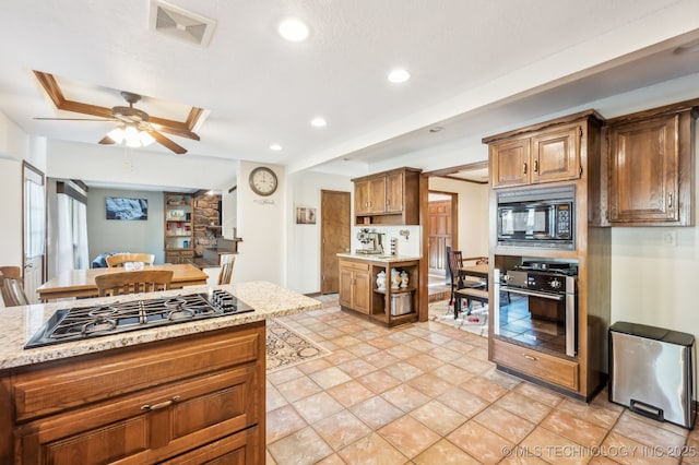 1604 S Chestnut Ave, Broken Arrow, OK 74012 - kitchen with oven, black microwave, gas stovetop, recessed lighting, and ceiling fan