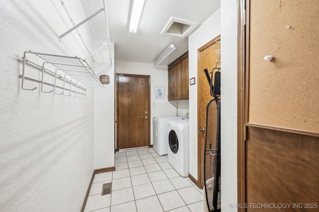 1604 S Chestnut Ave, Broken Arrow, OK 74012 - washroom featuring washer and clothes dryer, cabinet space, and light tile patterned floors