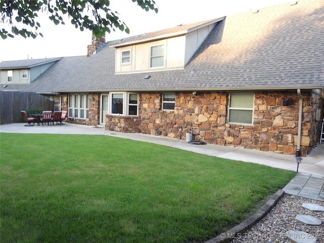 1604 S Chestnut Ave, Broken Arrow, OK 74012 - rear view of house with stone siding, a shingled roof, a patio, and a chimney