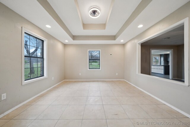 15338 S Brewster Rd, Mounds, OK 74047 - empty room with light tile patterned floors, a raised ceiling, baseboards, and recessed lighting