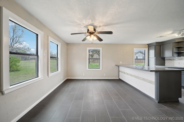 15338 S Brewster Rd, Mounds, OK 74047 - kitchen with a peninsula, ceiling fan, baseboards, and open shelves