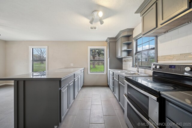 15338 S Brewster Rd, Mounds, OK 74047 - kitchen featuring visible vents, a sink, plenty of natural light, and double oven range