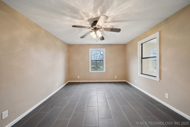 15338 S Brewster Rd, Mounds, OK 74047 - spare room featuring baseboards and a ceiling fan