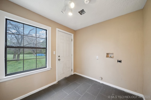15338 S Brewster Rd, Mounds, OK 74047 - washroom featuring hookup for an electric dryer, laundry area, dark tile patterned flooring, baseboards, and hookup for a washing machine