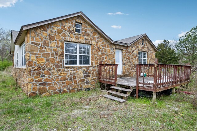 15338 S Brewster Rd, Mounds, OK 74047 - back of house with a wooden deck and stone siding