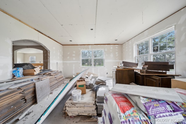 15338 S Brewster Rd, Mounds, OK 74047 - bedroom with arched walkways and concrete flooring
