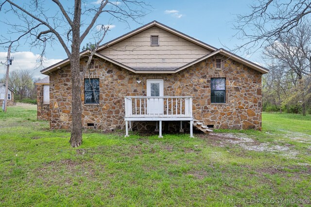 15338 S Brewster Rd, Mounds, OK 74047 - back of property with a lawn, crawl space, stone siding, and a deck