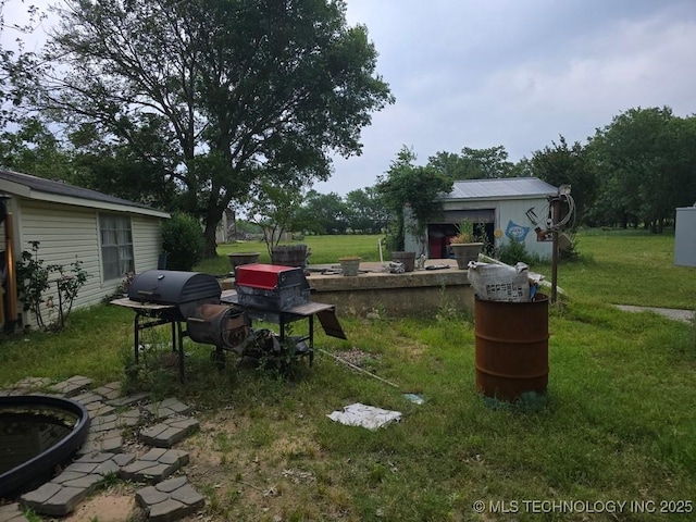 6750 Meridian Rd, Ardmore, OK 73401 - view of grassy yard featuring an outbuilding