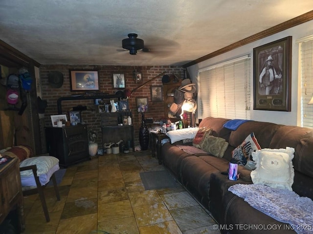 6750 Meridian Rd, Ardmore, OK 73401 - living area featuring ceiling fan, brick wall, crown molding, and stone finish flooring