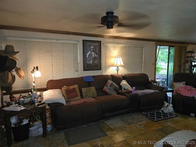 6750 Meridian Rd, Ardmore, OK 73401 - living room with stone tile flooring, a ceiling fan, and ornamental molding