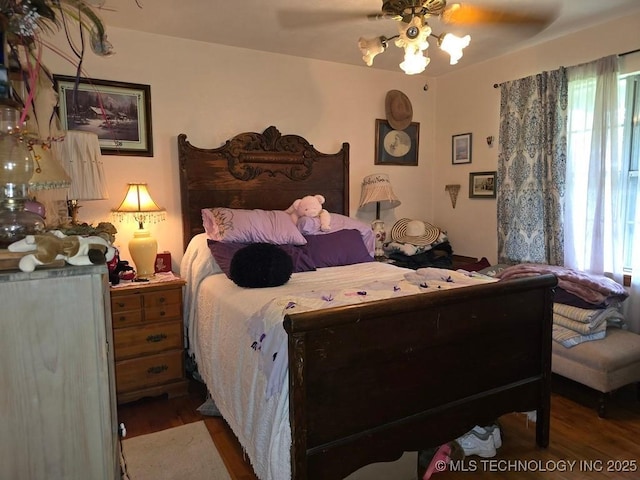 6750 Meridian Rd, Ardmore, OK 73401 - bedroom featuring wood finished floors, multiple windows, and a ceiling fan