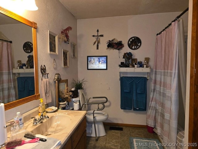 6750 Meridian Rd, Ardmore, OK 73401 - full bath with toilet, vanity, a textured wall, tile patterned flooring, and a shower with curtain