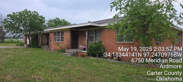 6750 Meridian Rd, Ardmore, OK 73401 - view of front facade featuring a front yard and brick siding