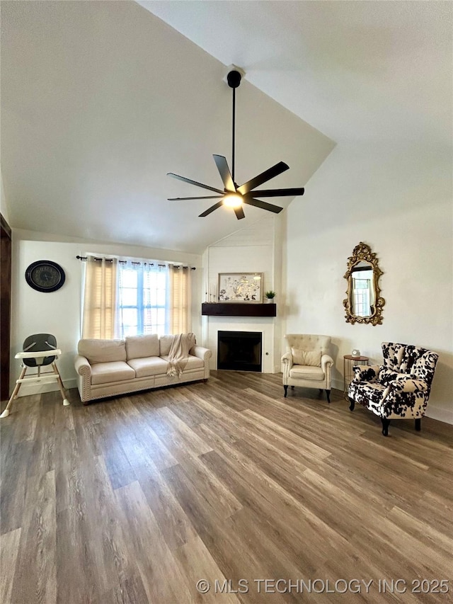 1110 S Catalina Dr, Oologah, OK 74053 - unfurnished living room featuring a ceiling fan, vaulted ceiling, wood finished floors, and a fireplace