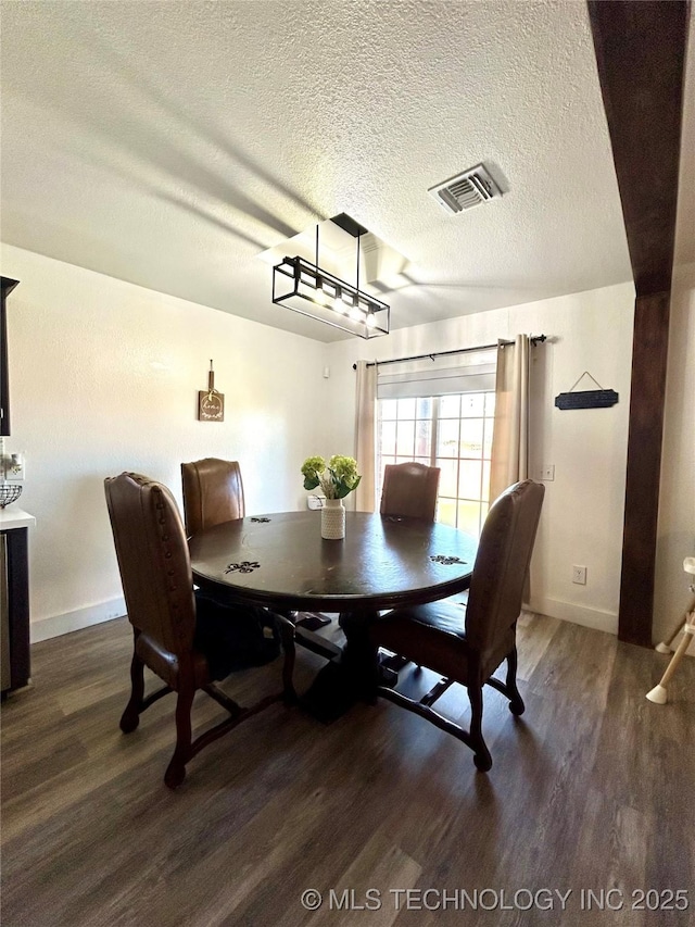 1110 S Catalina Dr, Oologah, OK 74053 - dining area featuring visible vents, baseboards, a textured ceiling, and wood finished floors