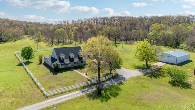 birds eye view of property featuring a view of trees and a rural view