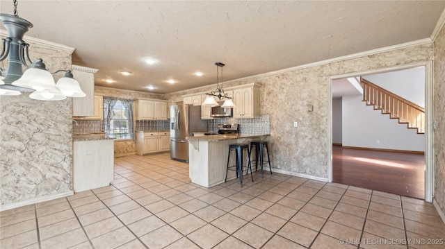 kitchen with tasteful backsplash, light tile patterned floors, a peninsula, crown molding, and stainless steel appliances