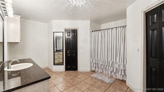 full bathroom with tile patterned floors, a shower with shower curtain, vanity, and baseboards
