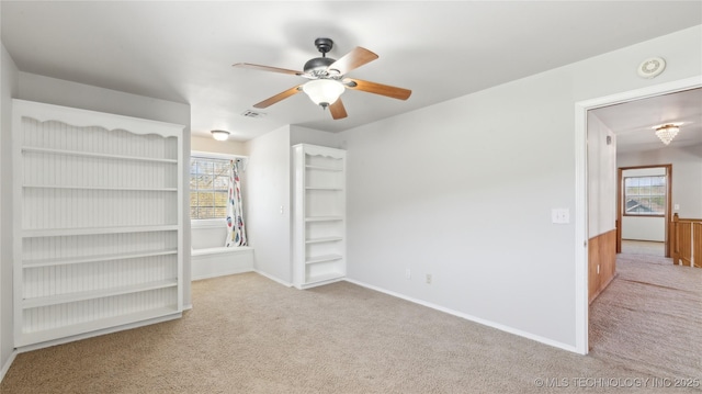 unfurnished bedroom with baseboards, a ceiling fan, and carpet