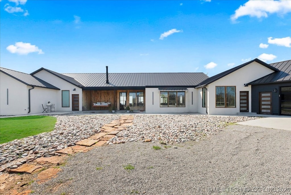 2081 County Road 3007, Bartlesville, OK 74003 - view of front of property featuring metal roof, stucco siding, and a standing seam roof