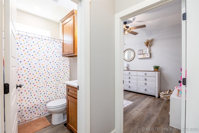 440 W 2nd St, Silo, OK 74701 - bathroom featuring a shower with curtain, toilet, ceiling fan, vanity, and wood finished floors