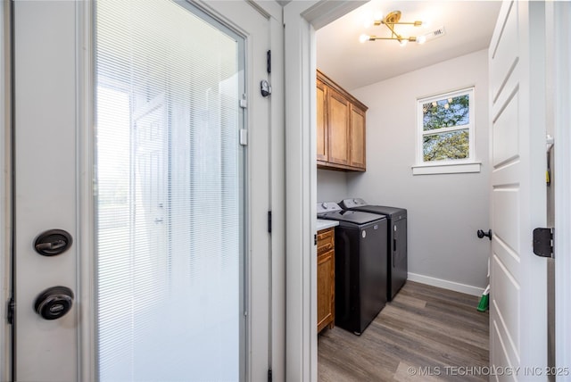 440 W 2nd St, Silo, OK 74701 - washroom featuring visible vents, baseboards, wood finished floors, cabinet space, and washing machine and dryer