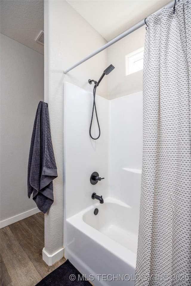 440 W 2nd St, Silo, OK 74701 - bathroom with baseboards, wood finished floors, and shower / bath combination with curtain