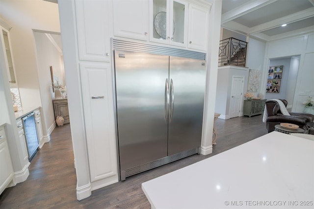 5716 W Austin St, Broken Arrow, OK 74011 - kitchen featuring built in refrigerator, dark wood finished floors, white cabinets, glass insert cabinets, and beamed ceiling