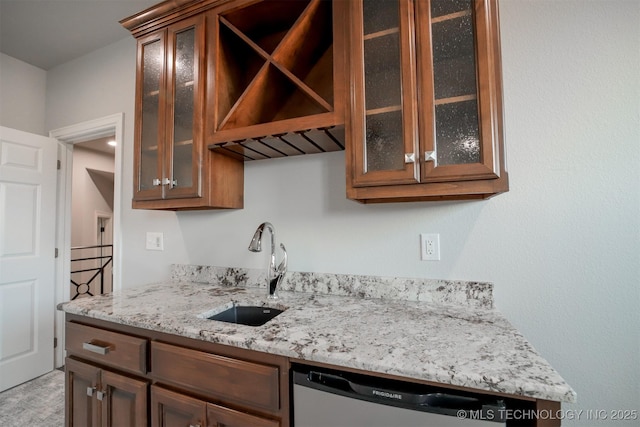 5716 W Austin St, Broken Arrow, OK 74011 - kitchen with stainless steel dishwasher, light stone countertops, glass insert cabinets, and brown cabinetry