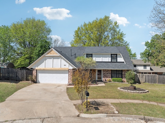 traditional home with fence, a front yard, driveway, and an attached garage