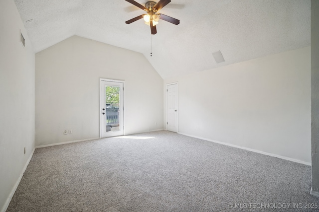 empty room featuring ceiling fan, carpet, baseboards, a textured ceiling, and lofted ceiling