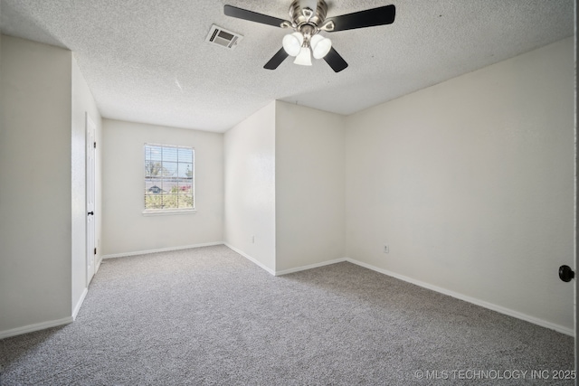 unfurnished room with visible vents, ceiling fan, a textured ceiling, and carpet