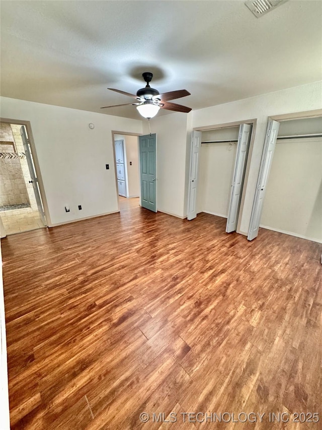 5101 S Spruce Dr, Sand Springs, OK 74063 - unfurnished bedroom featuring light wood-type flooring, baseboards, and multiple closets