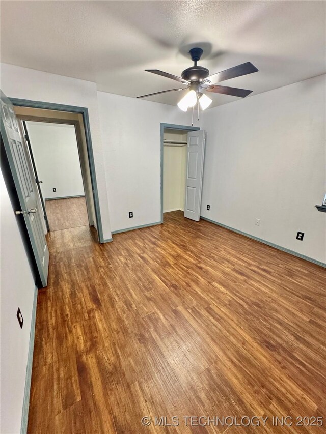 5101 S Spruce Dr, Sand Springs, OK 74063 - unfurnished bedroom with baseboards, ceiling fan, and wood finished floors