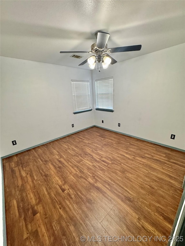 5101 S Spruce Dr, Sand Springs, OK 74063 - spare room with visible vents, ceiling fan, wood finished floors, and baseboards