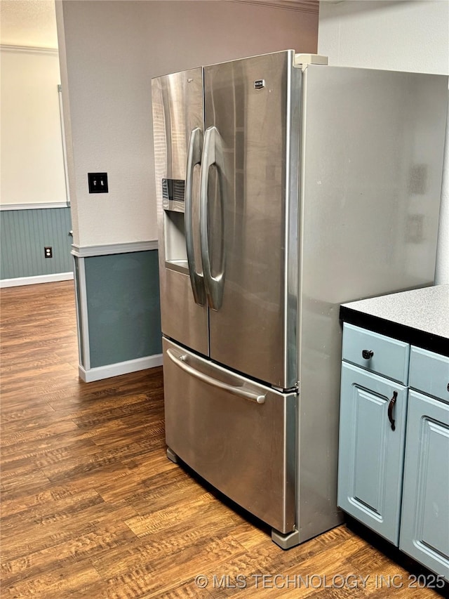 5101 S Spruce Dr, Sand Springs, OK 74063 - kitchen featuring baseboards, stainless steel fridge, dark wood-style flooring, a wainscoted wall, and blue cabinets