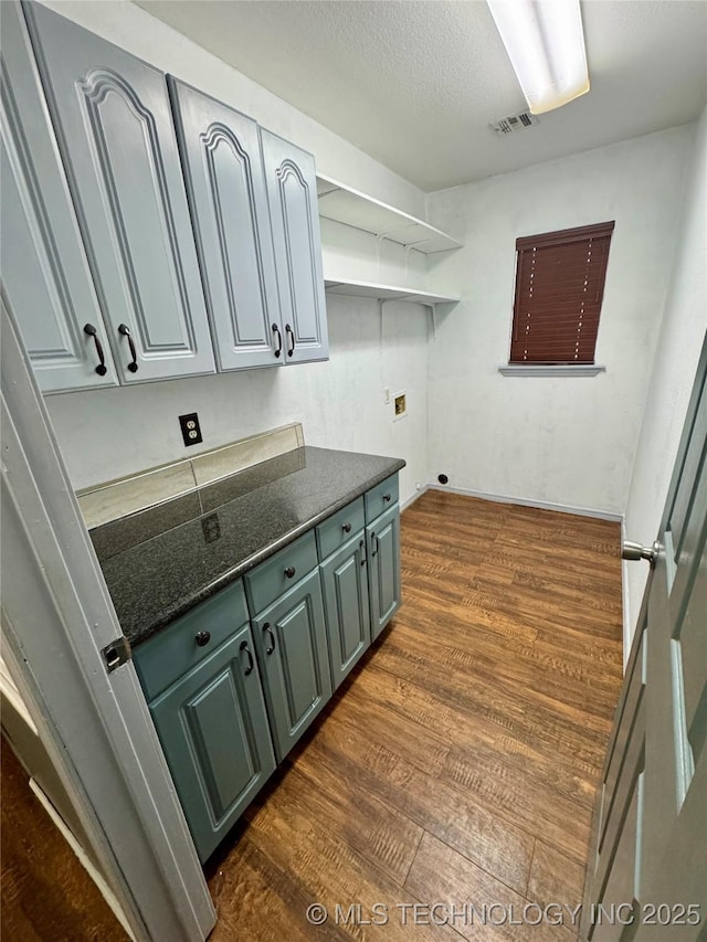 5101 S Spruce Dr, Sand Springs, OK 74063 - clothes washing area featuring visible vents, dark wood-style floors, hookup for a washing machine, and cabinet space
